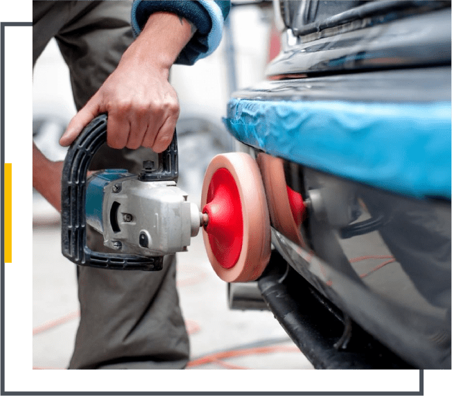 A person using an electric sander to clean the car.